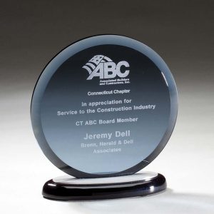 Smoked glass award mounted on black base with brushed aluminum accents
