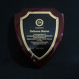 9.5 inch crest shaped rosewood piano finish plaque with gold trim