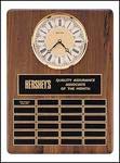 15'' x 21'' walnut plaque with solid brass diamond-spun bezel with glass lens, ivory dial and three hand movement