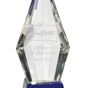 Faceted crystal obelisk on blue base