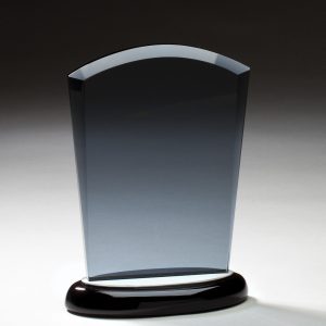 Smoked glass award mounted on a black base with brushed aluminum accents