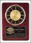 12'' x 15'' rosewood piano finished clock with black and gold dial and three-hand movement